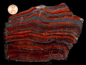 Figure 3: Banded iron formations, or BIFs, consist of layers of iron-rich sediments buried between shale and chert. They provide an important source of iron for making automobiles, and provide evidence for the lack of oxygen gas on the early Earth.