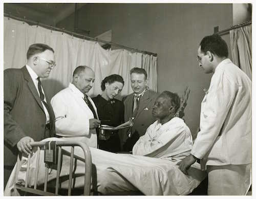 Figure 6: Dr. Louis T. Wright and colleagues at patient bedside, Harlem Hospital, New York, N.Y.