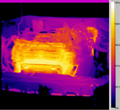 Figure 3: An infrared image of a running engine showing the temperature of various parts of the engine. Higher temperatures (red and yellow portions of the image) indicate greater heat loss. The loss of heat represents a loss of efficiency in the engine, and a contribution to the increasing entropy of the universe.