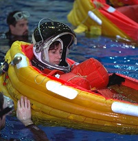 Figura 3: Ellen Ochoa y sus compañeros de tripulación practican desplegar balsas salvavidas durante un entrenamiento de rescate de emergencia en el Laboratorio de Flotabilidad Neutral en el Johnson Space Center en 1999.