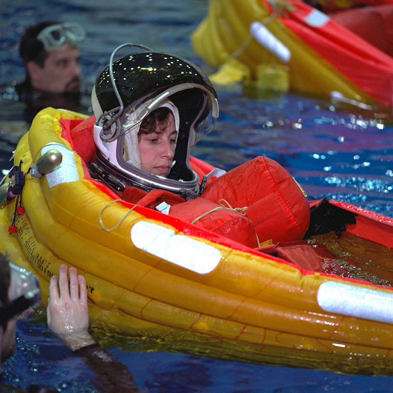Figure 3: Ellen Ochoa and her crewmates practice deploying life rafts during emergency bailout training in the Johnson Space Center’s Neutral Buoyancy Lab in 1999.