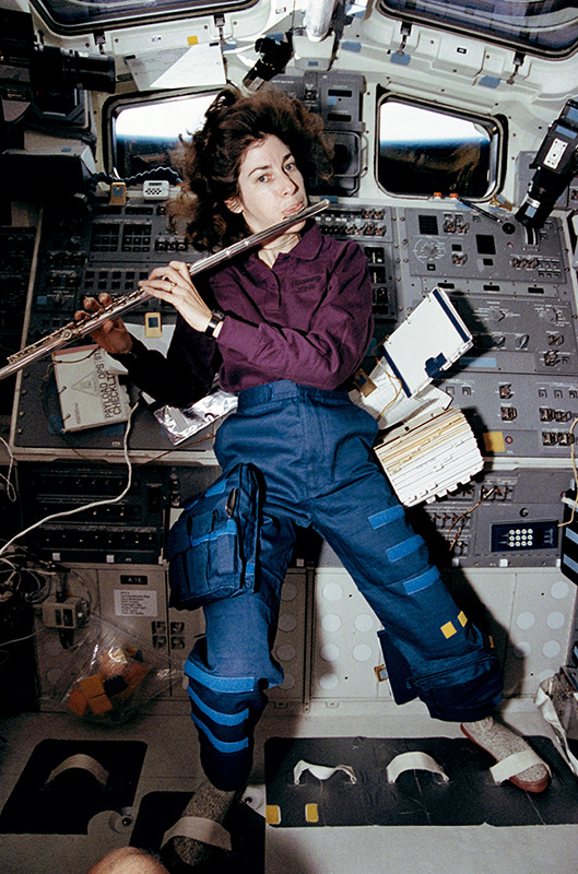 Figure 5: Ellen Ochoa taking a brief break from work on STS-56 to play a few songs on her flute.