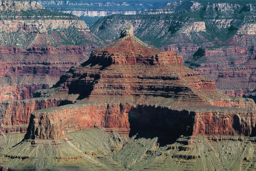 Figure 4: Redbeds, like the Supai group exposed on the sheer cliffs of Isis Temple in the Grand Canyon, are ancient soils that have a bright red color due to the abundant oxidized iron they contain. Redbeds only began to form 2 billion years ago, when the atmosphere contained enough oxygen gas to react with the iron in the sediments.