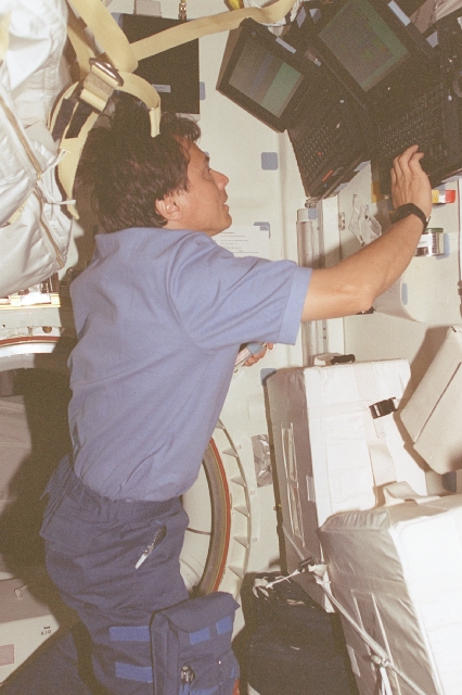 Figure 5: Chang Díaz inputs data on a laptop computer associated with the Alpha Magnetic Spectrometer (AMS) hardware, the first large magnet experiment ever placed in Earth orbit.