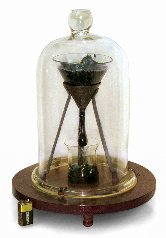 Figure 10: The Pitch Drop Experiment at the University of Queensland (battery shown for size comparison).