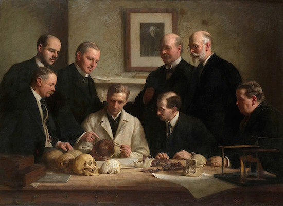 Figure 7: Charles Dawson and Arthur Smith Woodward (back right) with other researchers examining the Piltdown Man skull.