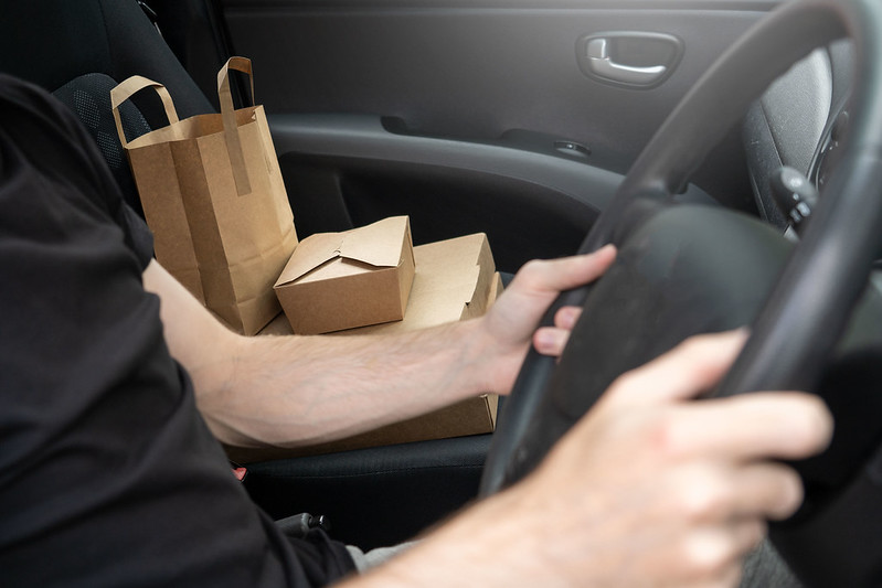 Figure 3: Person driving food delivery car.
